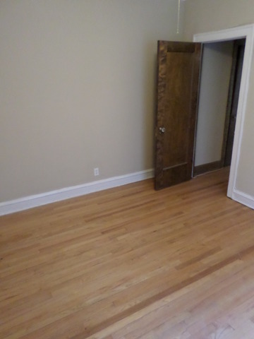 1011 Hull Terrace, Unit 22 Evanston, IL 60202 - Photo 6 of 10 a view of an empty room with wooden floor
