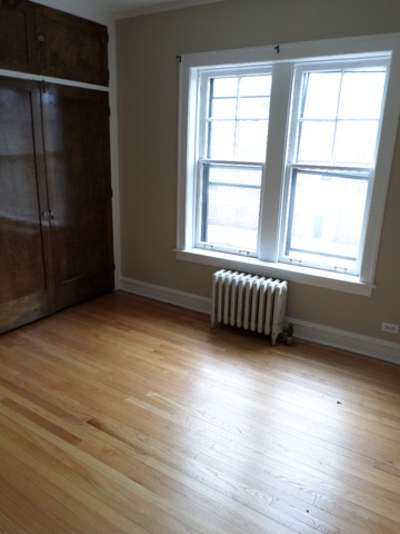1011 Hull Terrace, Unit 22 Evanston, IL 60202 - Photo 8 of 10 an empty room with wooden floor and windows