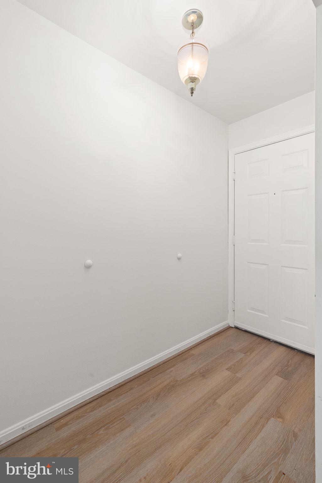 2407 Normandy Square Place, Unit C Silver Spring, MD 20906 - Photo 2 of 19 a view of an empty room with wooden floor