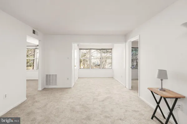 an empty room with windows and closet
