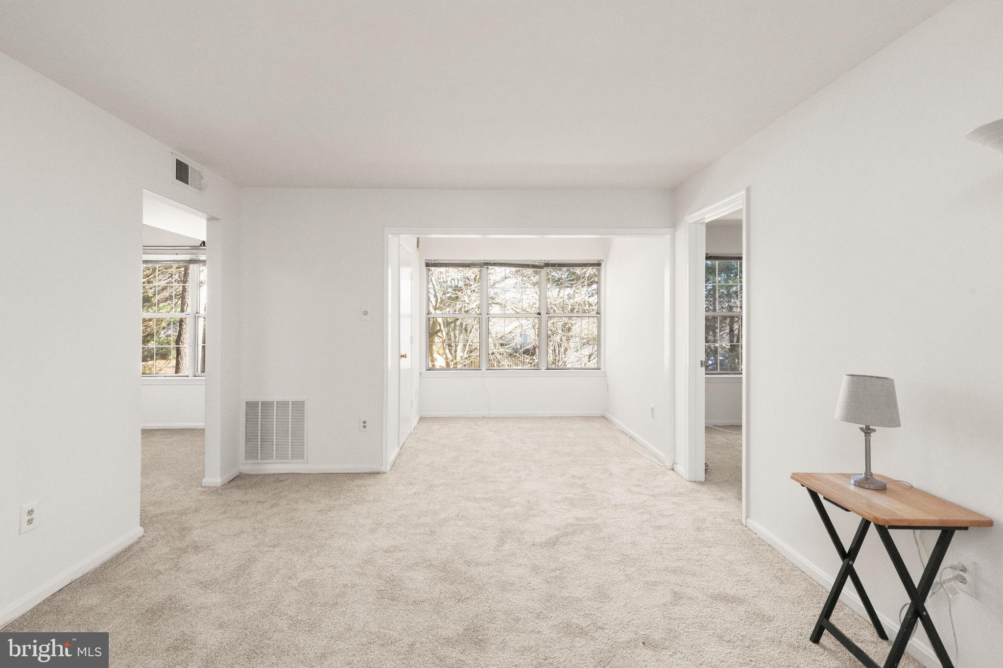 2407 Normandy Square Place, Unit C Silver Spring, MD 20906 - Photo 5 of 19 an empty room with windows and closet
