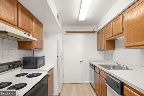 a kitchen with a sink stove and refrigerator