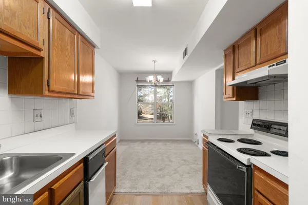 a kitchen that has a sink and a stove