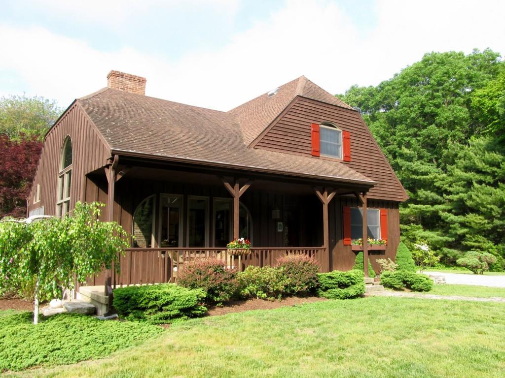 552 Chesterfield Road Montville, CT 06370 - Photo 1 of 1 a view of a house with potted plants and large trees