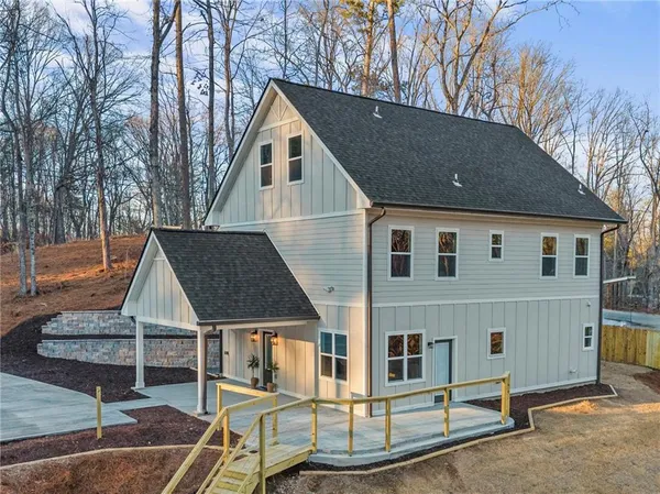 a dining room with wooden floor a chandelier a wooden table and chairs