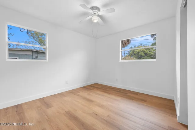 a view of room with window and ceiling fan