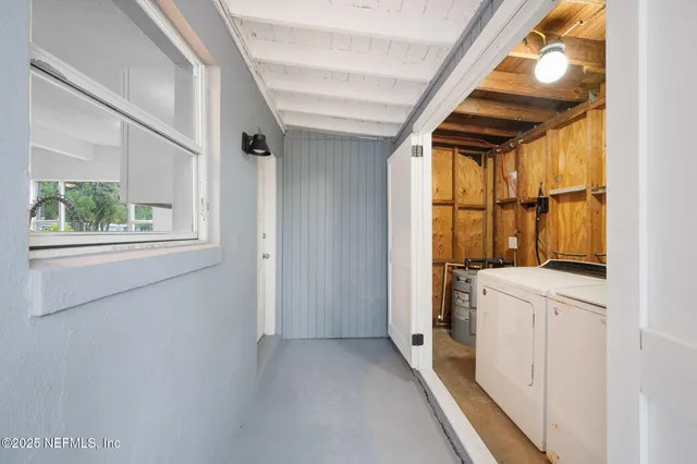 a view of a storage & utility room with dryer and washer