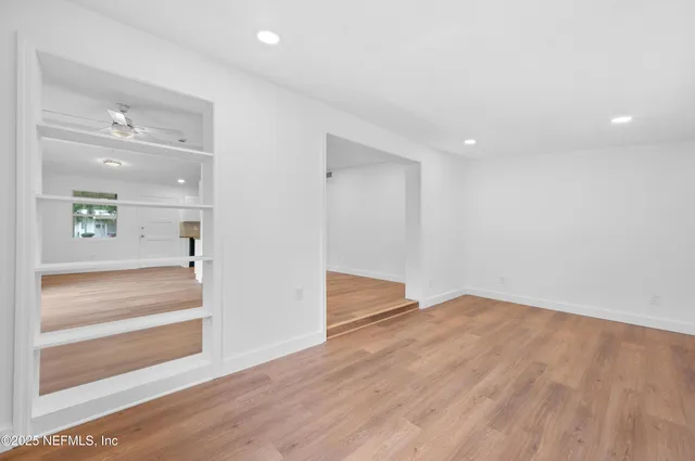 a view of an entryway with wooden floor