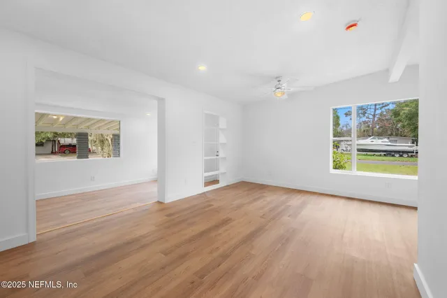 wooden floor in an empty room with a window