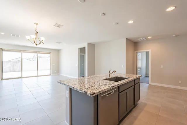 a kitchen with granite countertop sink and cabinets