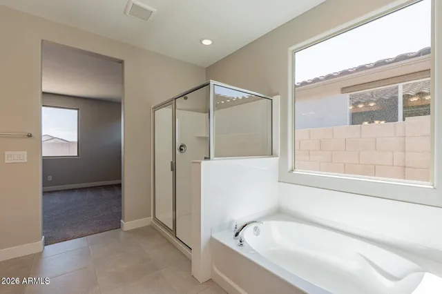a bathroom with a bathtub and a shower