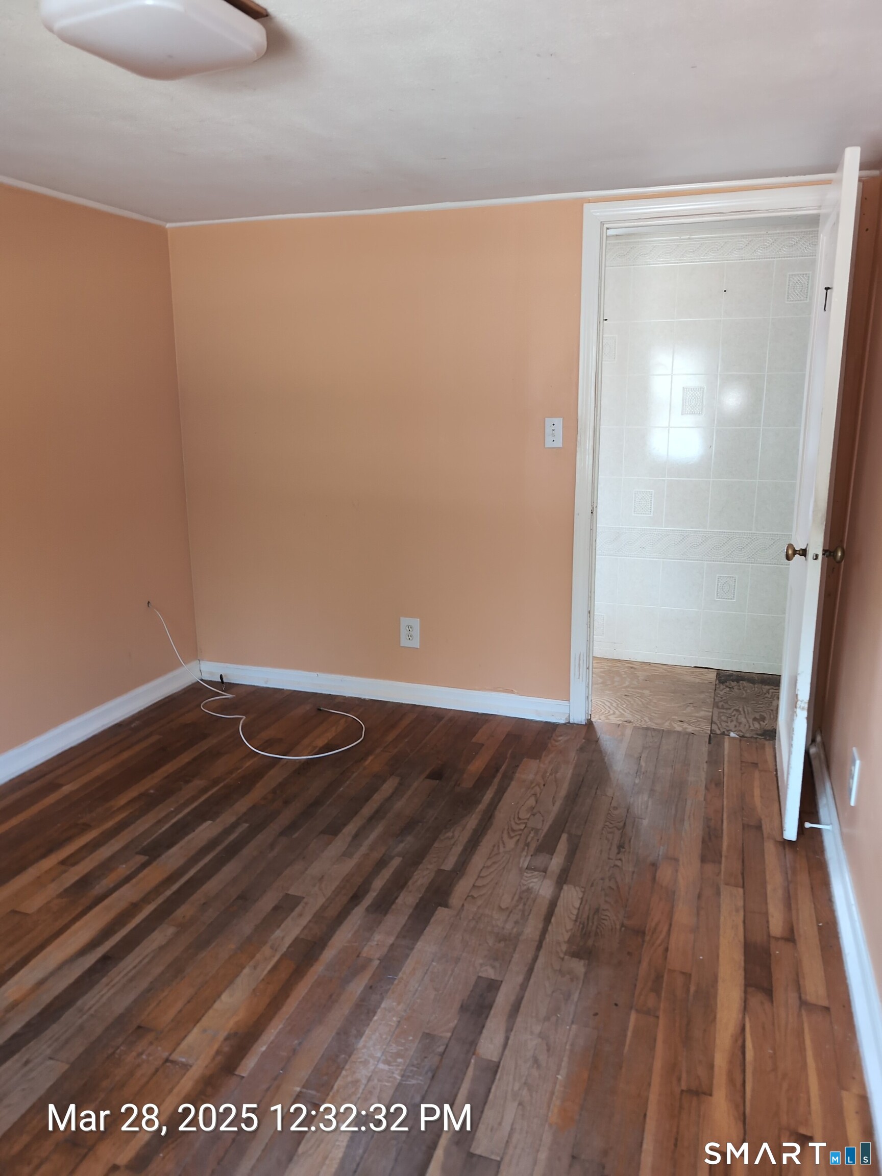 97 Bushy Hill Road Deep River, CT 06417 - Photo 16 of 28 a view of a room with wooden floor and staircase
