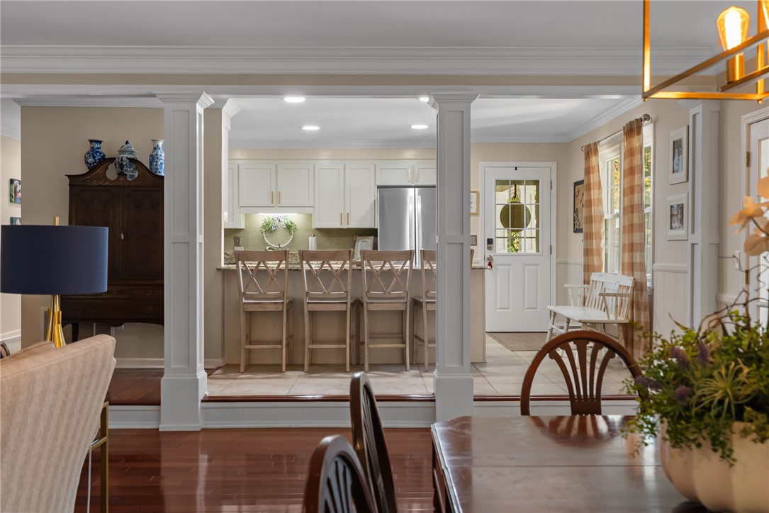 3513 Hopewell Road Anderson, SC 29621 - Photo 23 of 50 An inviting open-concept layout features rich wood flooring connecting to a tiled kitchen with a breakfast bar.