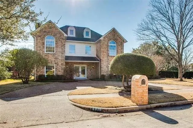 a front view of a house with a yard garage and outdoor seating