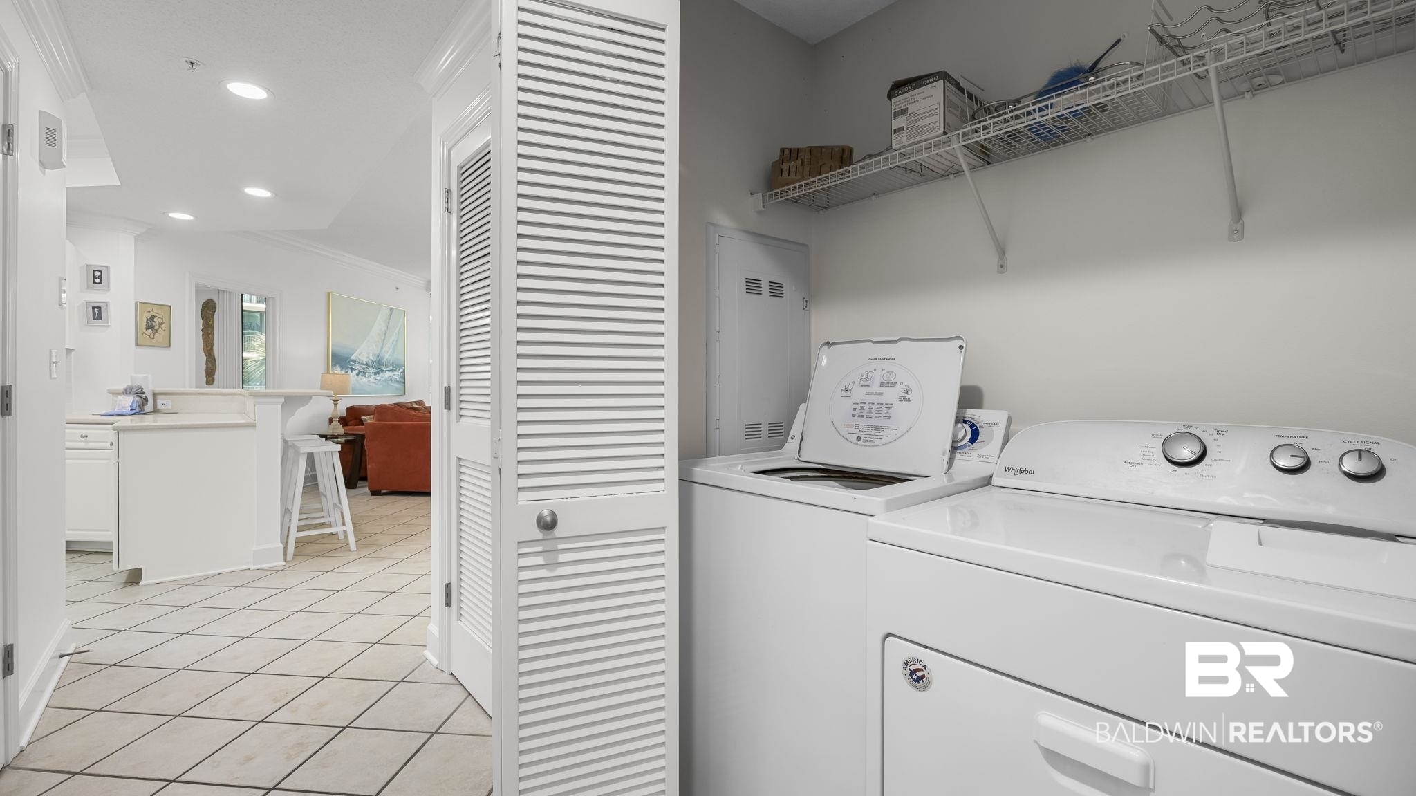 27580 Canal Road, Unit 1213 Orange Beach, AL 36561 - Photo 18 of 27 Dedicated laundry area featuring a white top-load washing machine, white electric dryer, and convenient wire shelving for storage