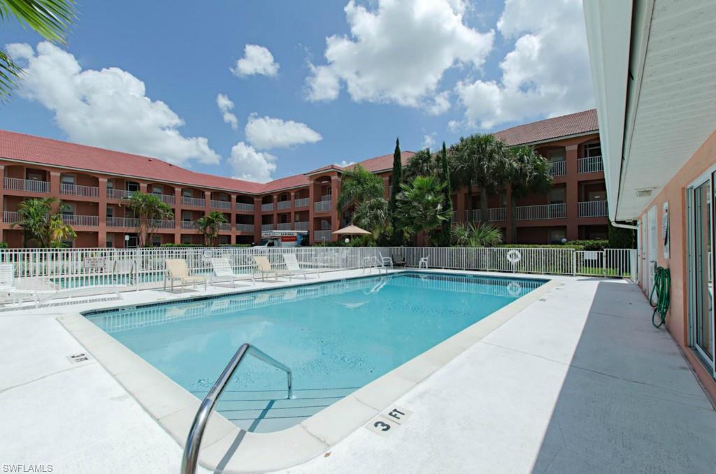519 Roma Court, Unit 3301 Naples, FL 34110 - Photo 11 of 14 a view of a swimming pool with a patio and a yard