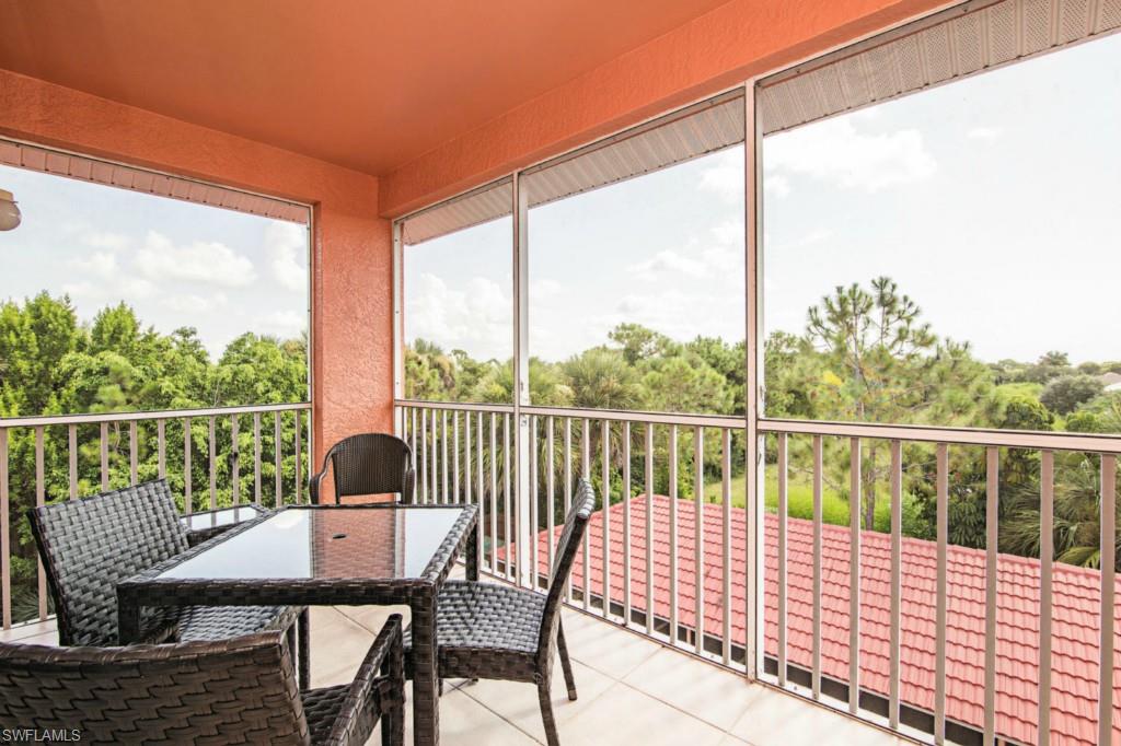 519 Roma Court, Unit 3301 Naples, FL 34110 - Photo 14 of 14 a view of a balcony with a table and chairs
