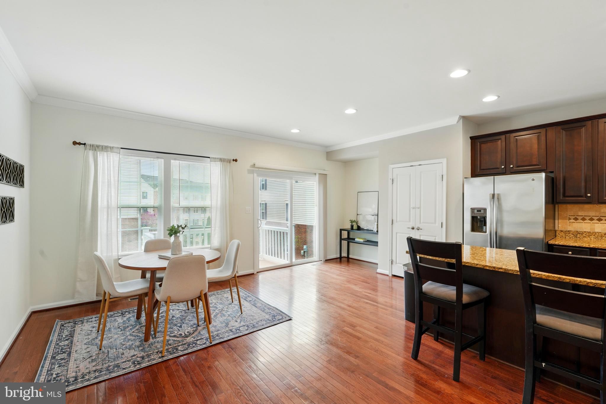 7054 Kona Drive Gainesville, VA 20155 - Photo 13 of 39 a living room with furniture a large window and wooden floor