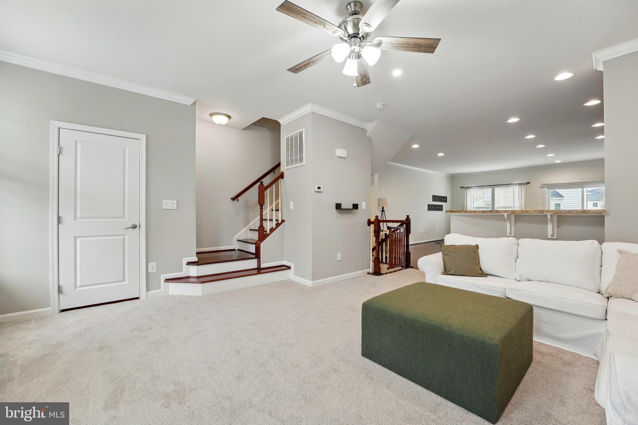 7054 Kona Drive Gainesville, VA 20155 - Photo 20 of 39 a living room with furniture and a ceiling fan
