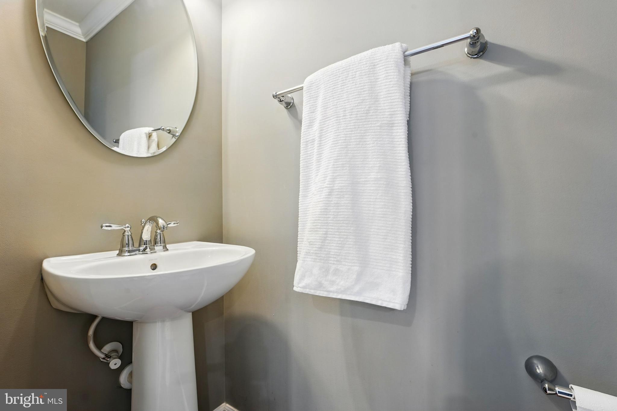7054 Kona Drive Gainesville, VA 20155 - Photo 21 of 39 a bathroom with a sink a mirror and a shower