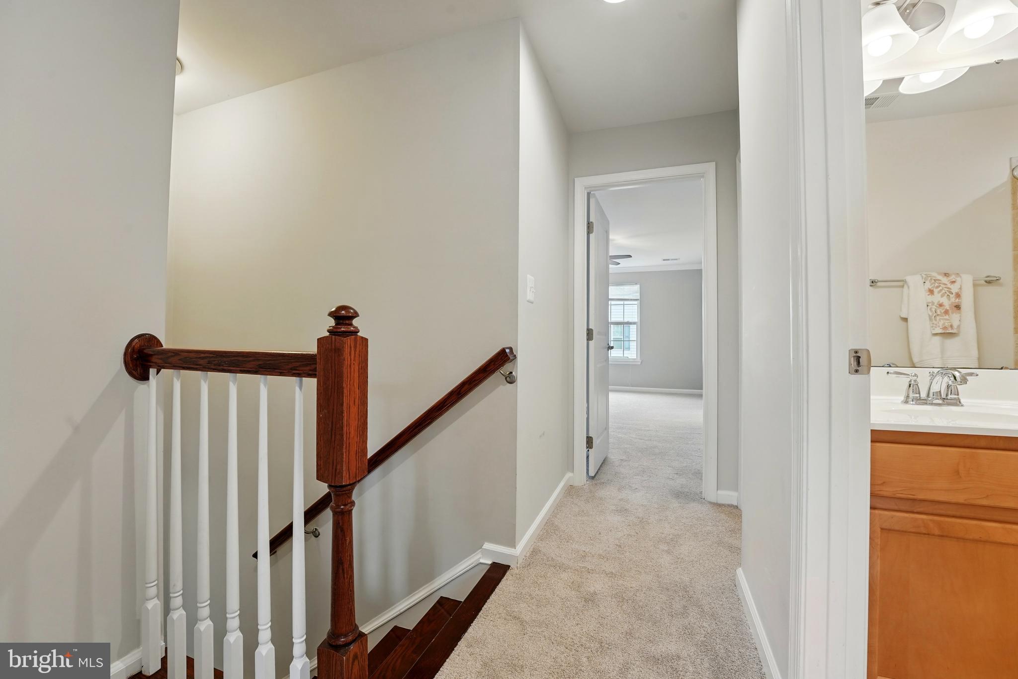 7054 Kona Drive Gainesville, VA 20155 - Photo 22 of 39 a view of a hallway with wooden floor and staircase