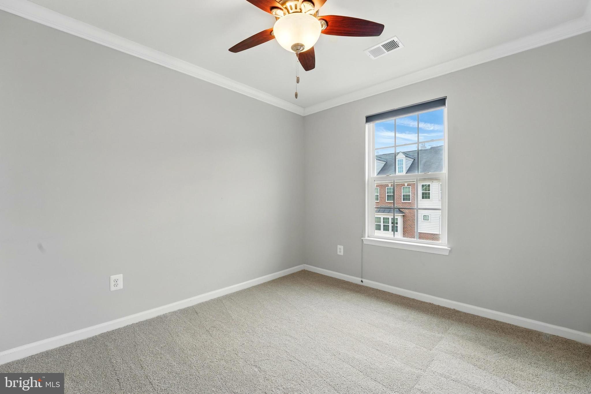 7054 Kona Drive Gainesville, VA 20155 - Photo 25 of 39 an empty room with a window and a fan