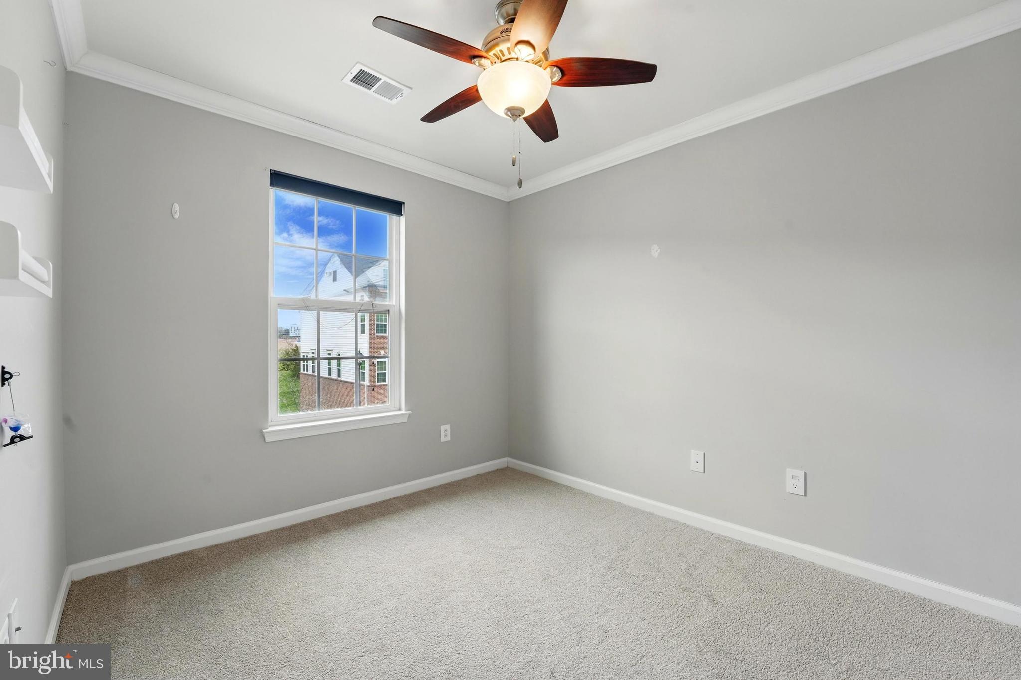 7054 Kona Drive Gainesville, VA 20155 - Photo 26 of 39 an empty room with a window and a fan