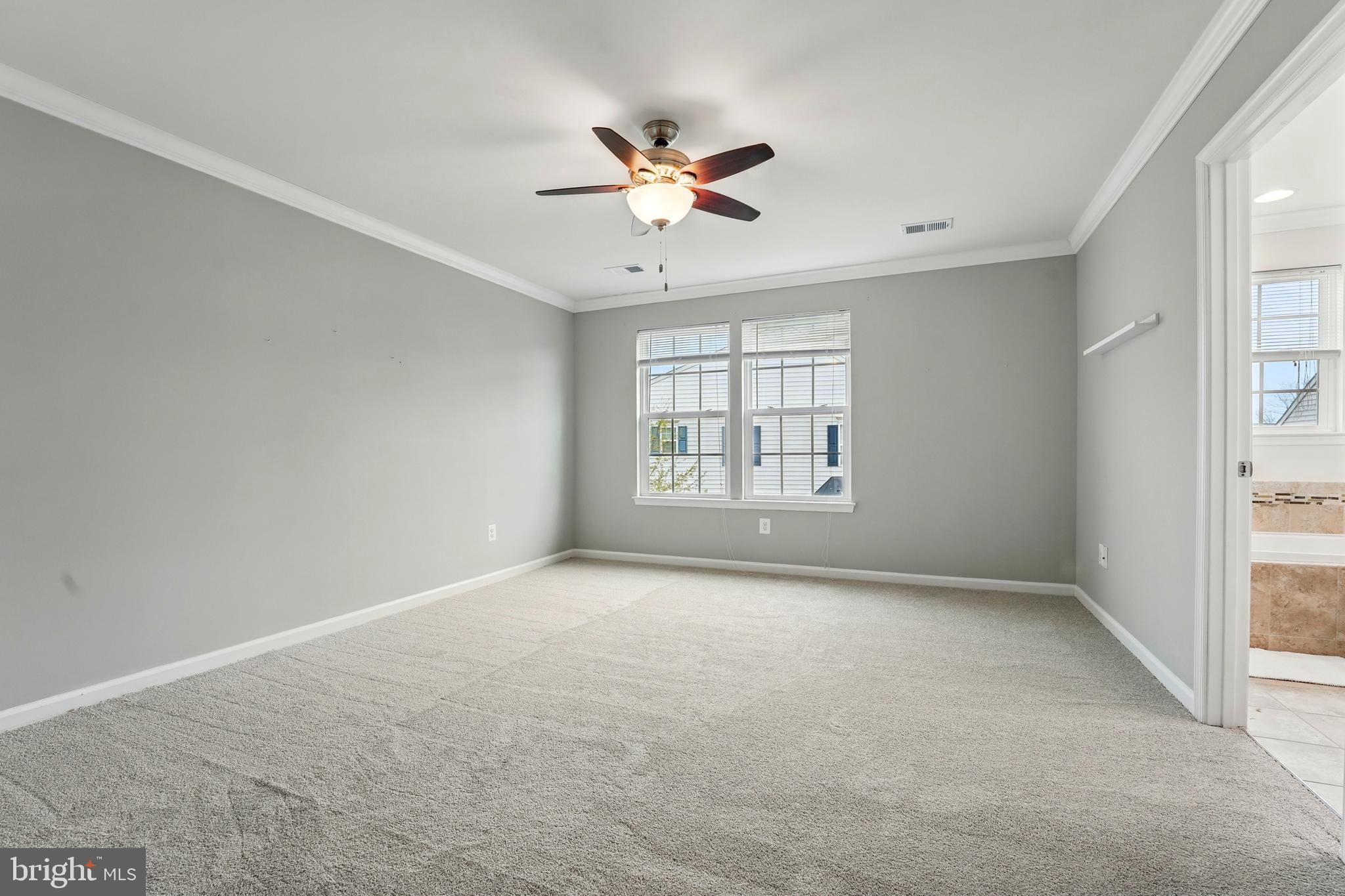 7054 Kona Drive Gainesville, VA 20155 - Photo 29 of 39 an empty room with windows and ceiling fan