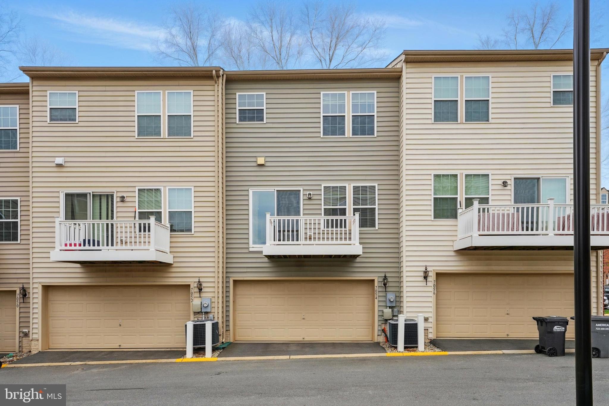 7054 Kona Drive Gainesville, VA 20155 - Photo 35 of 39 a front view of a house with a garage
