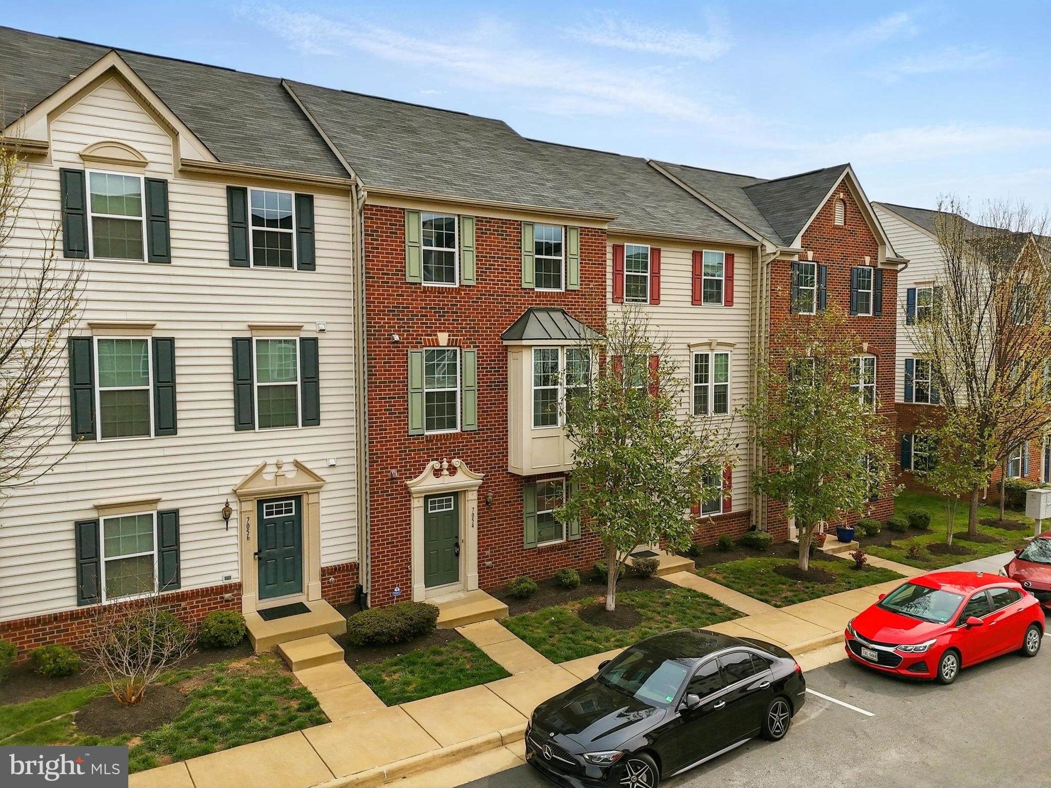 7054 Kona Drive Gainesville, VA 20155 - Photo 4 of 39 a front view of a house with cars parked