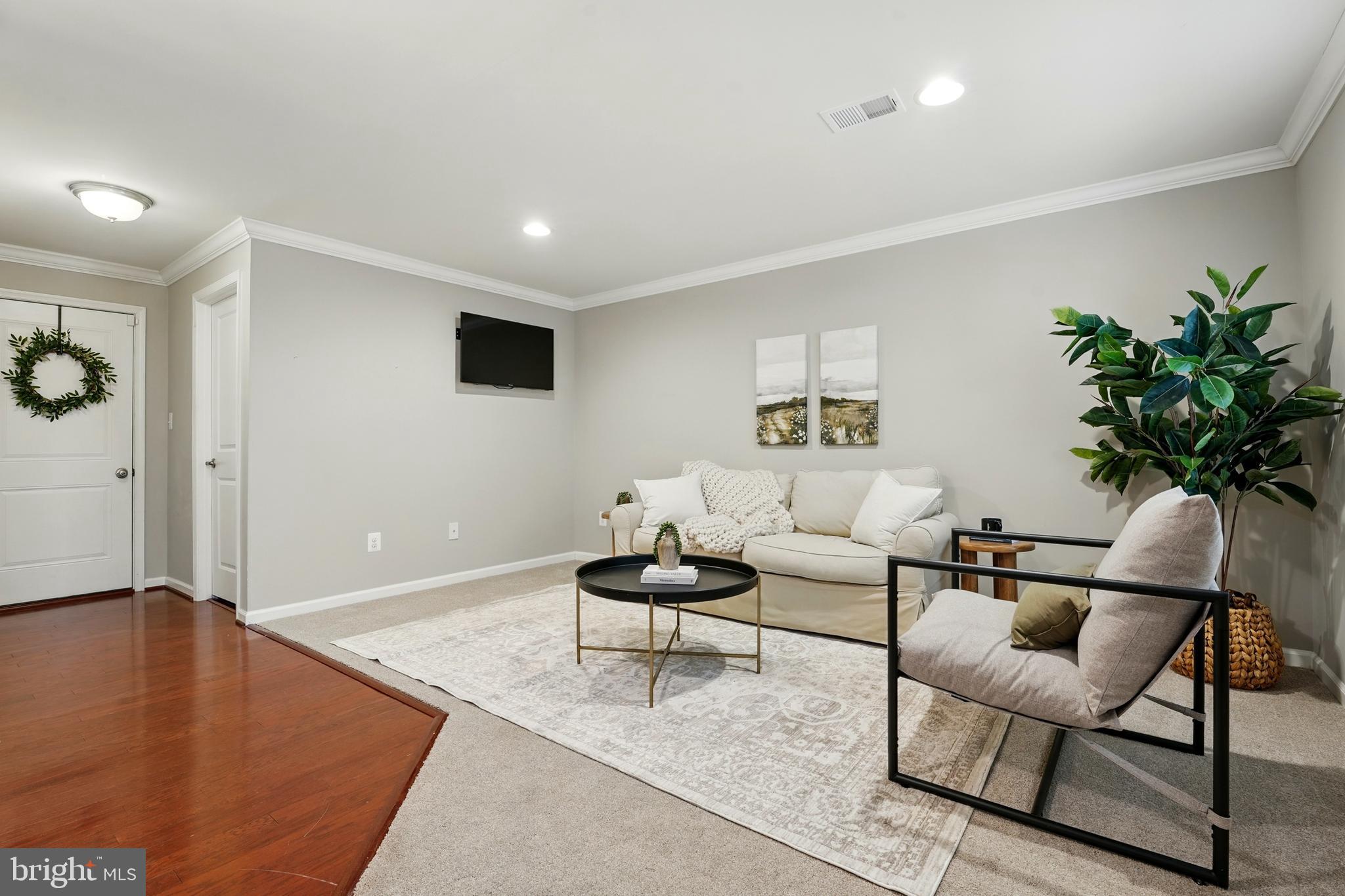 7054 Kona Drive Gainesville, VA 20155 - Photo 5 of 39 a living room with furniture and a potted plant
