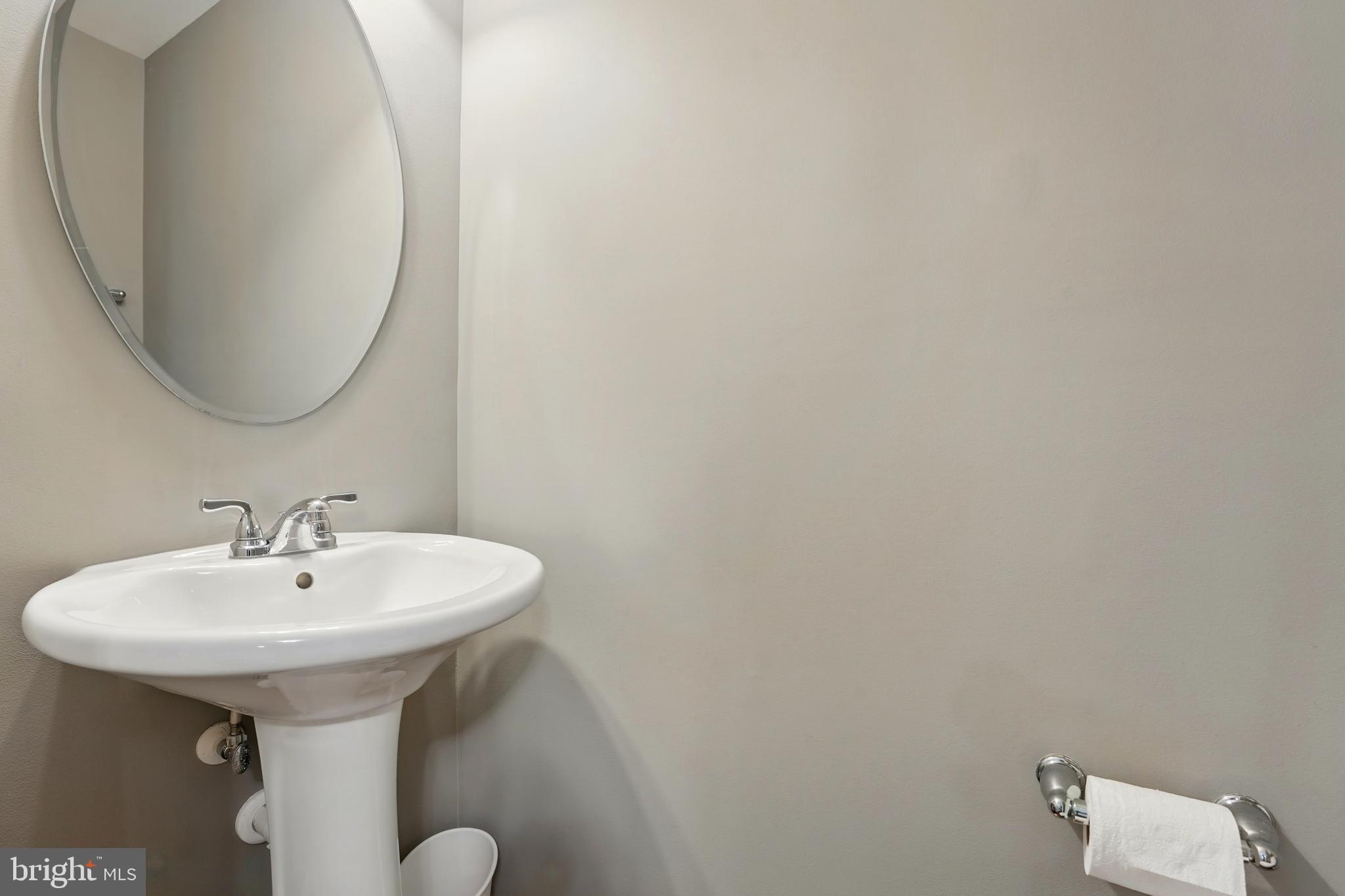 7054 Kona Drive Gainesville, VA 20155 - Photo 9 of 39 a bathroom with a sink and a mirror