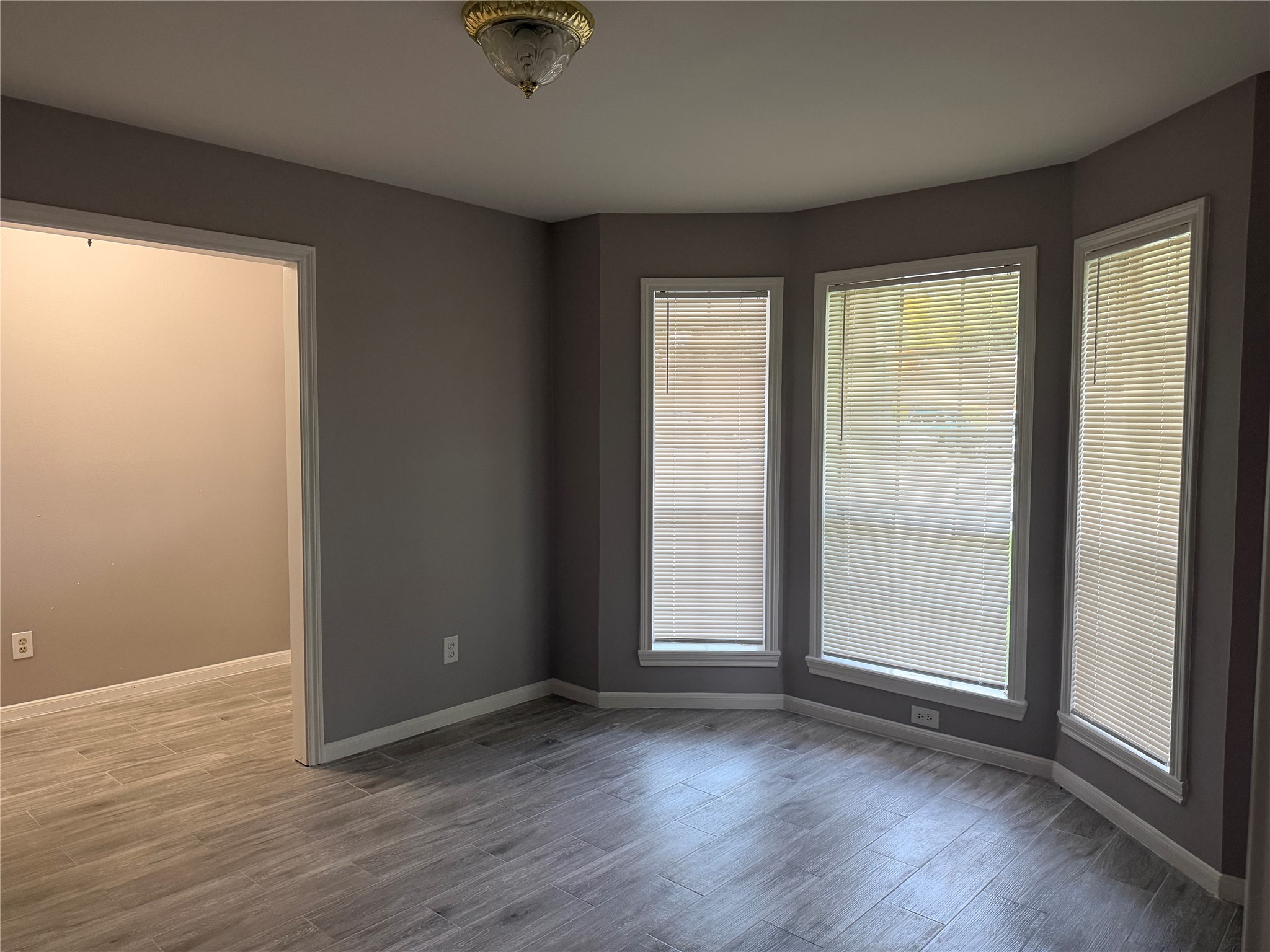 3815 Avenue R Rosenberg, TX 77471 - Photo 6 of 14 an empty room with wooden floor and windows