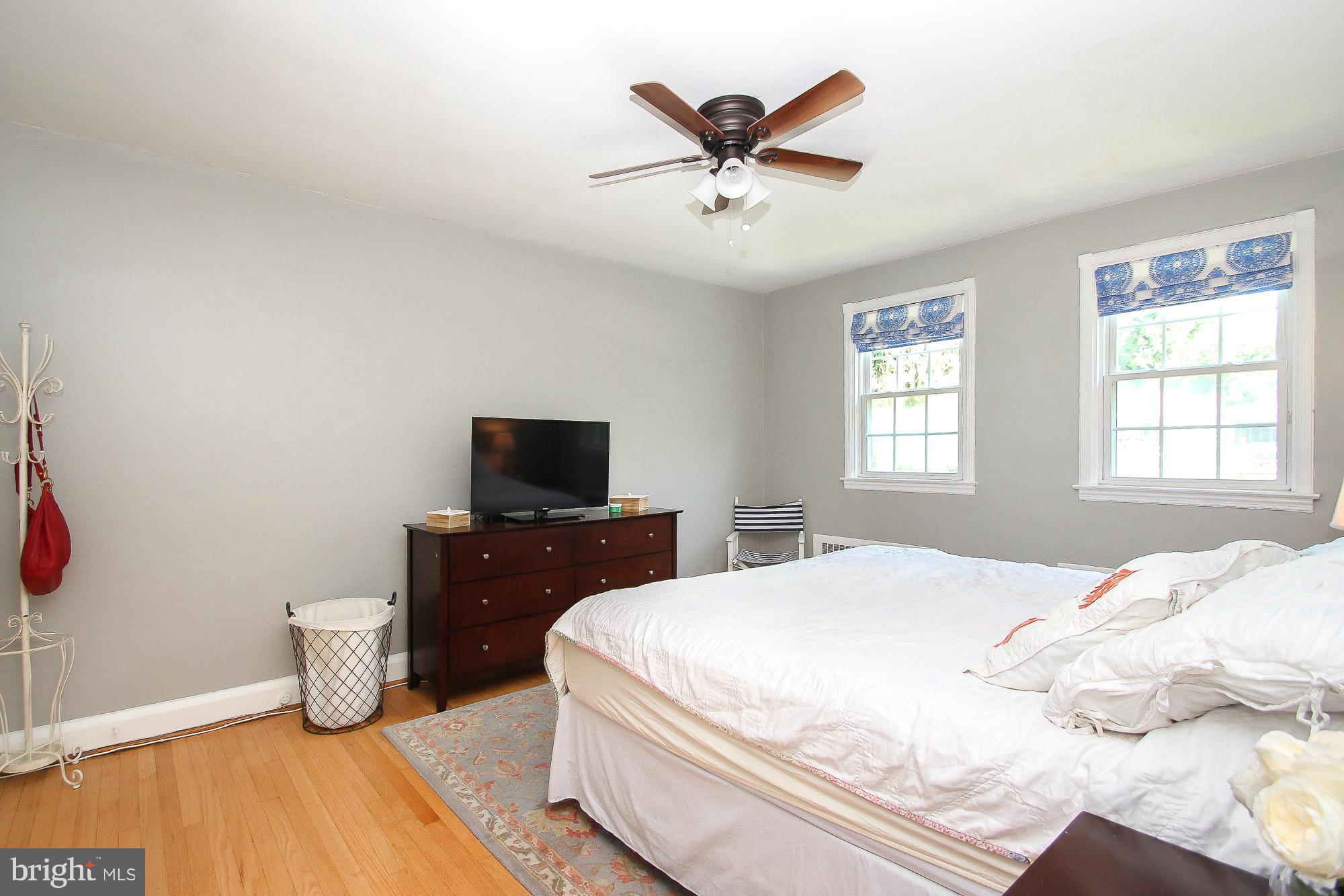 305 Dumbarton Road Baltimore, MD 21212 - Photo 14 of 30 a bedroom with a bed and a flat screen tv