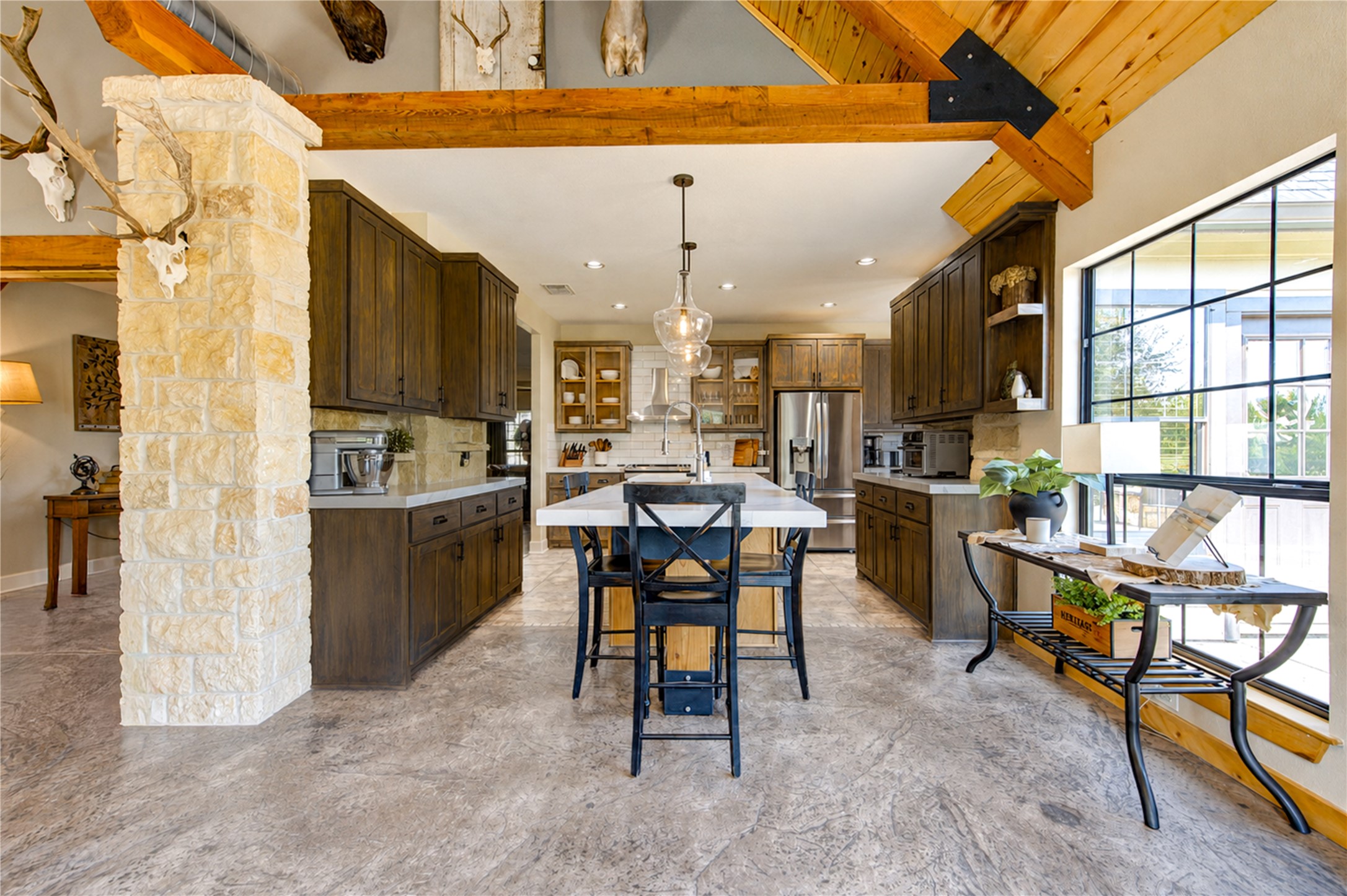 22313 Chapman Road Hempstead, TX 77445 - Photo 12 of 50 Above the island features oversized glass pendant lighting.