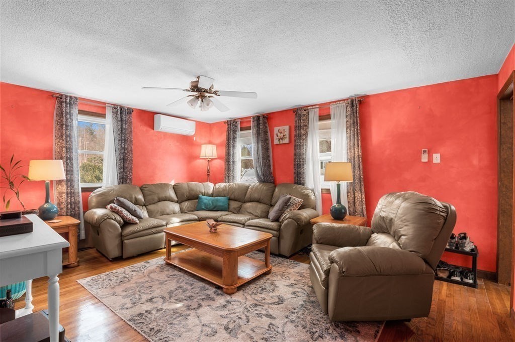 53 Birch Meadow Road Merrimac, MA 01860 - Photo 12 of 38 a living room with furniture a ceiling fan and a large window
