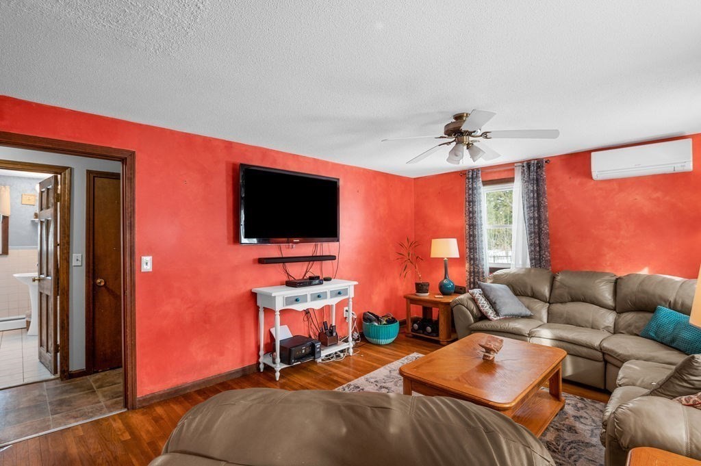 53 Birch Meadow Road Merrimac, MA 01860 - Photo 13 of 38 a bedroom with furniture and a flat screen tv