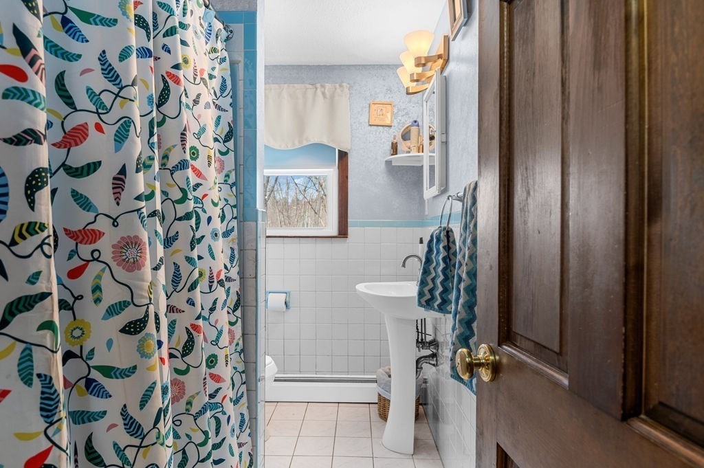 53 Birch Meadow Road Merrimac, MA 01860 - Photo 14 of 38 a bathroom with a shower and a curtain