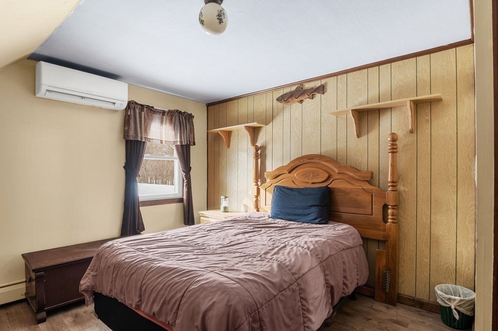 53 Birch Meadow Road Merrimac, MA 01860 - Photo 23 of 38 a bedroom with a bed and wooden floor