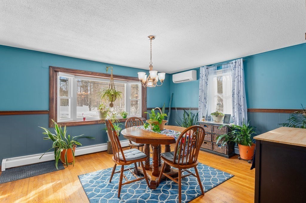 53 Birch Meadow Road Merrimac, MA 01860 - Photo 4 of 38 a dining room with furniture potted plants and wooden floor