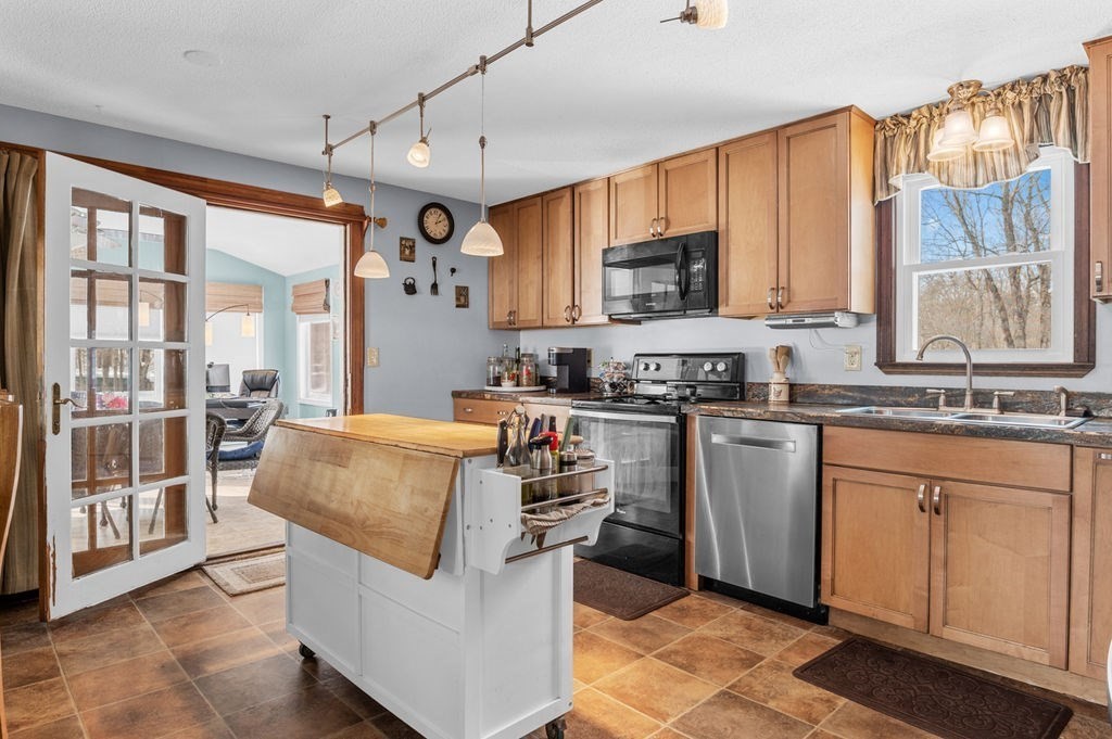 53 Birch Meadow Road Merrimac, MA 01860 - Photo 7 of 38 a kitchen with stainless steel appliances granite countertop a stove a sink and a refrigerator