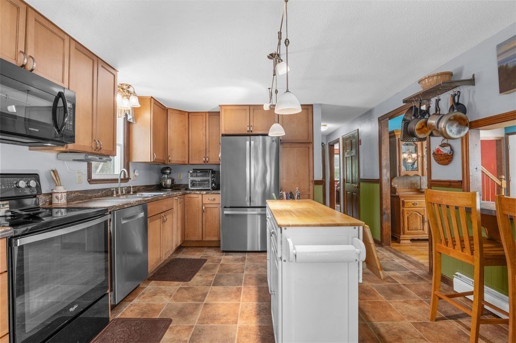 53 Birch Meadow Road Merrimac, MA 01860 - Photo 9 of 38 a kitchen with stainless steel appliances granite countertop a refrigerator a stove top oven a sink and dishwasher