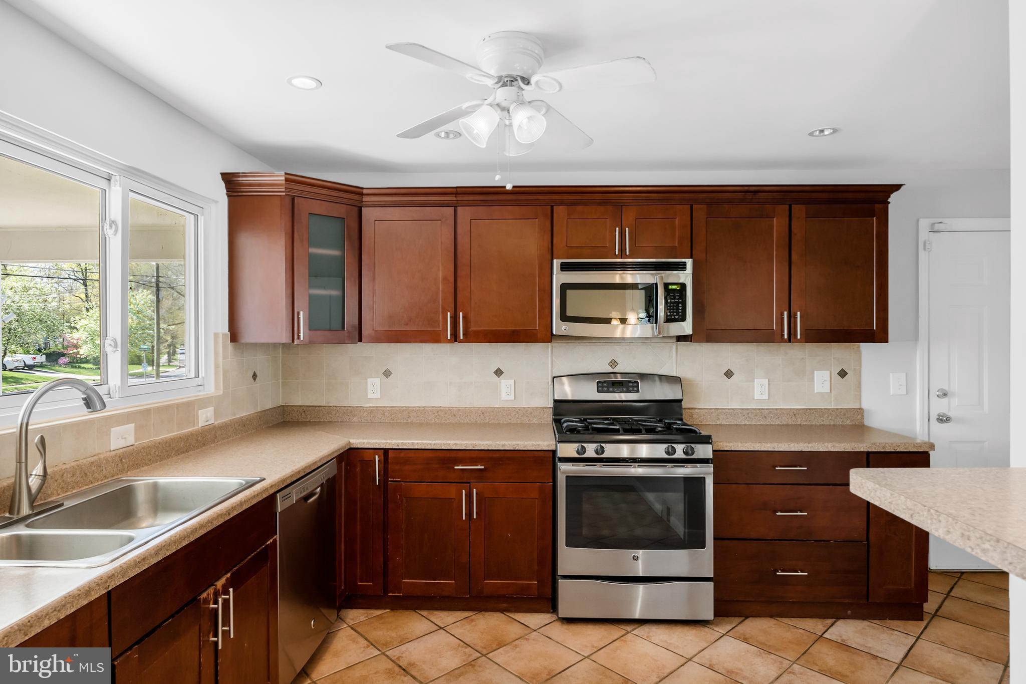 104 Sharrowvale Road Cherry Hill, NJ 08034 - Photo 14 of 37 a kitchen with granite countertop a stove sink and microwave