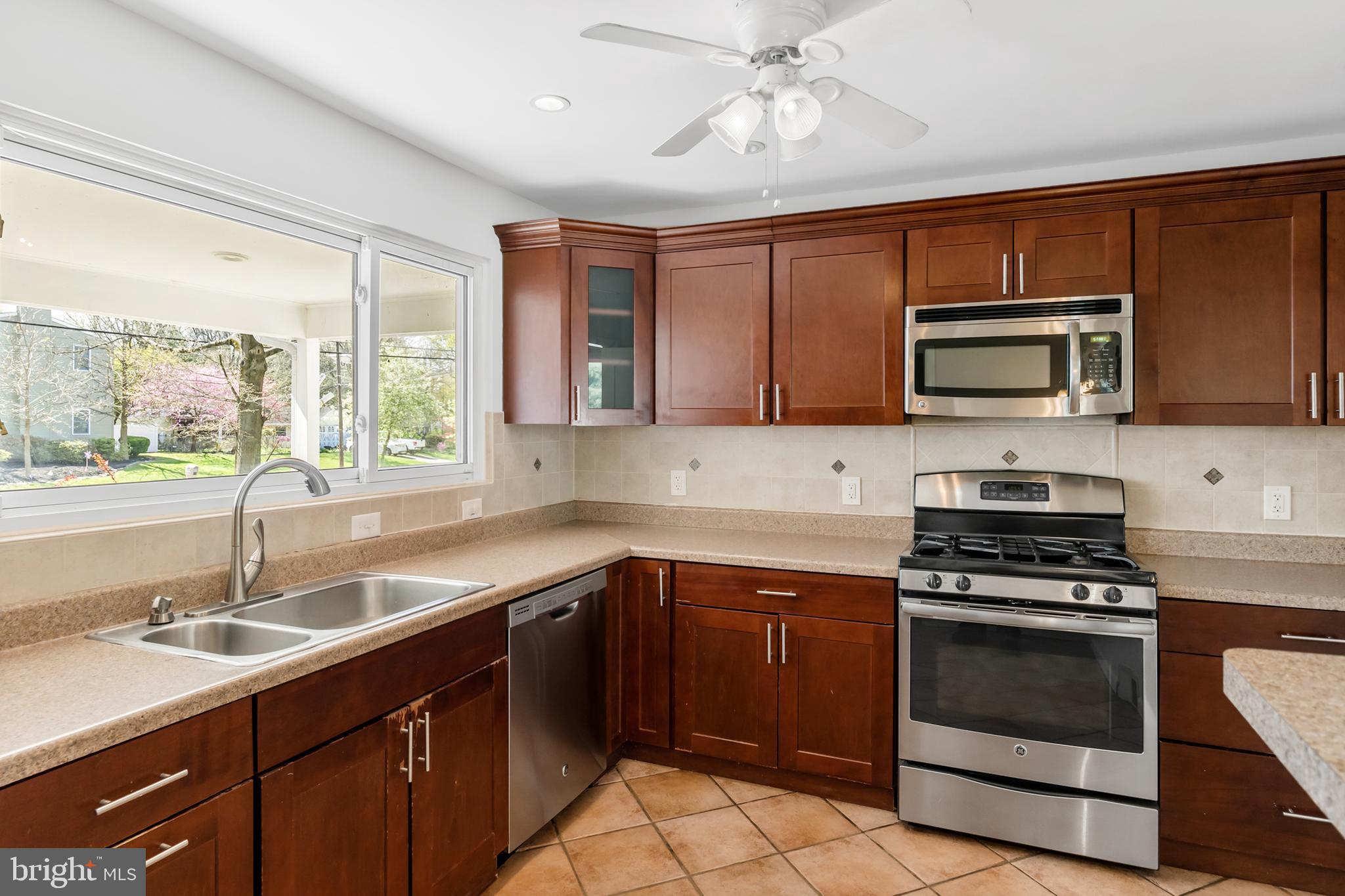 104 Sharrowvale Road Cherry Hill, NJ 08034 - Photo 18 of 37 a kitchen with a sink stove and microwave