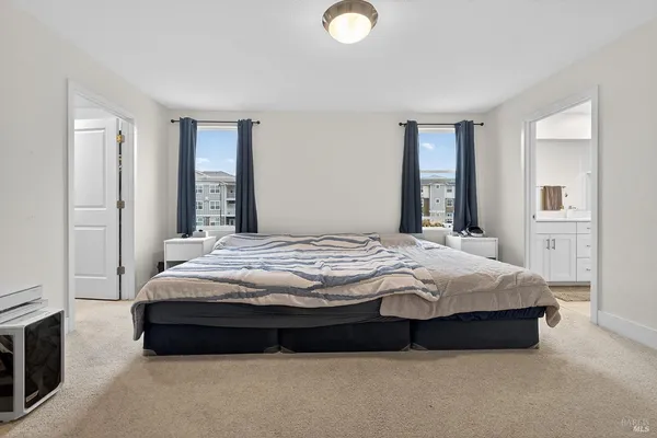 a bedroom with a bed lamp and a fireplace