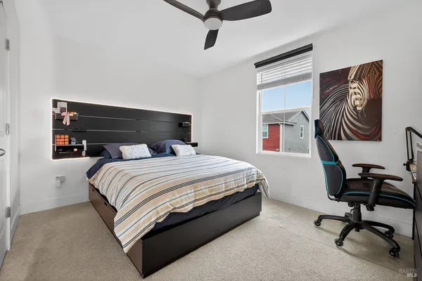 a bedroom with a bed and a chair