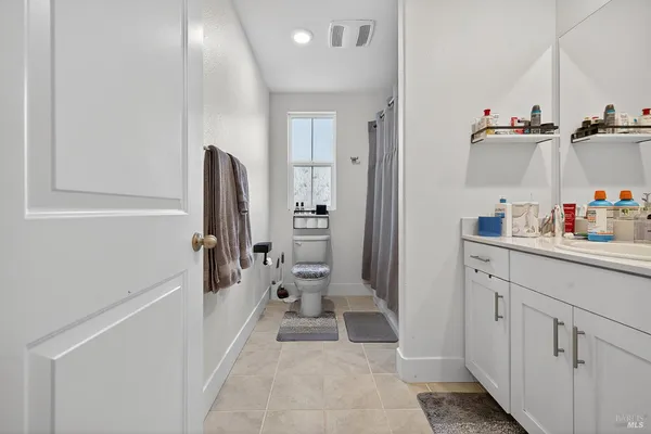 a bathroom with a sink and mirror with bathtub