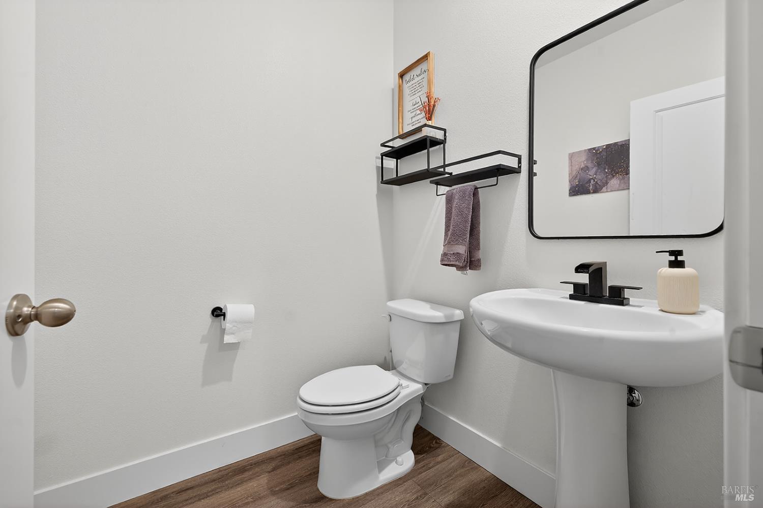 6042 Oxford Place Rohnert Park, CA 94928 - Photo 21 of 31 a bathroom with a toilet sink and mirror
