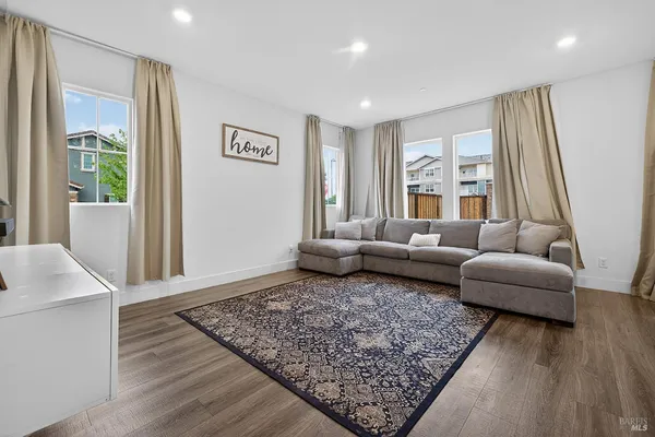 a living room with furniture and a rug