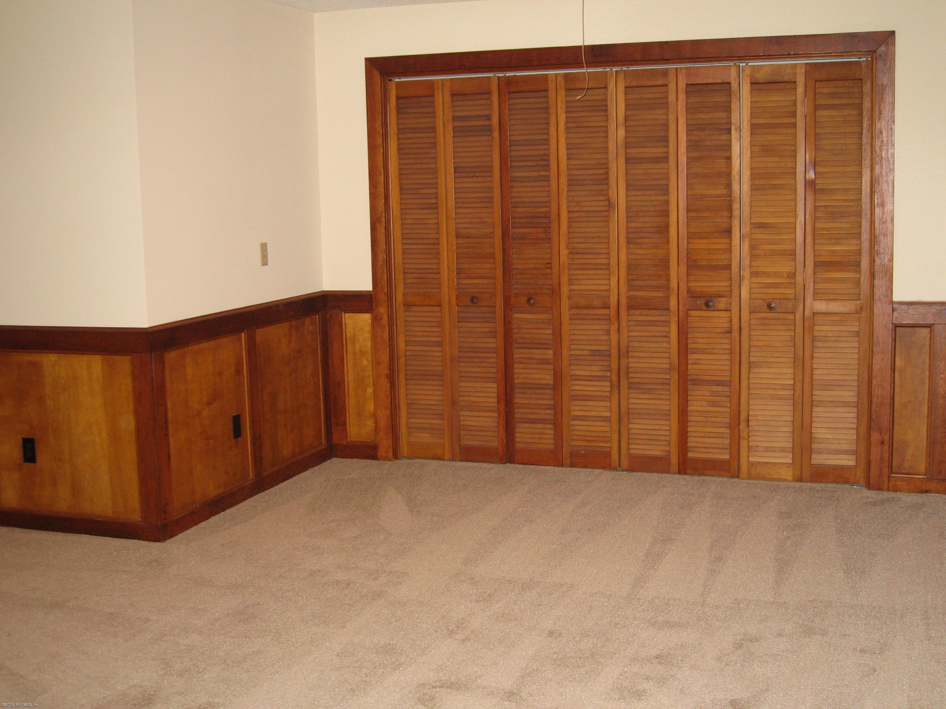 6139 Suwanee Road Jacksonville, FL 32217 - Photo 10 of 10 an empty room with a wooden door
